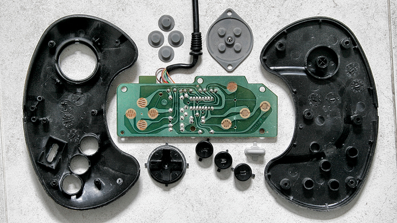 Illustration for article titled Deconstructed Gaming Controllers Reveal Gorgeous Old School Guts
